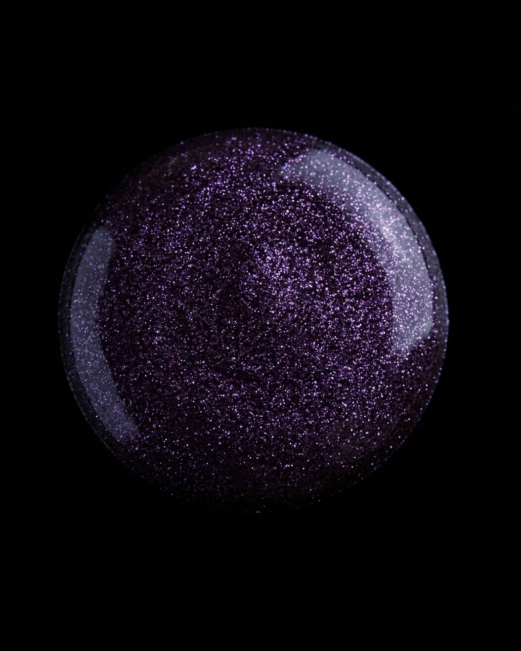 Purple glittery drop on a black background