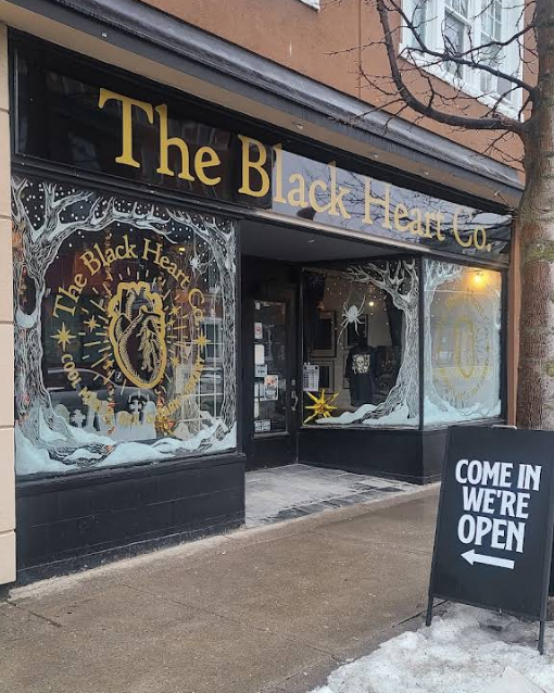 The storefront of 'The Black Heart Co.' with large gold lettering on a black sign above the entrance.