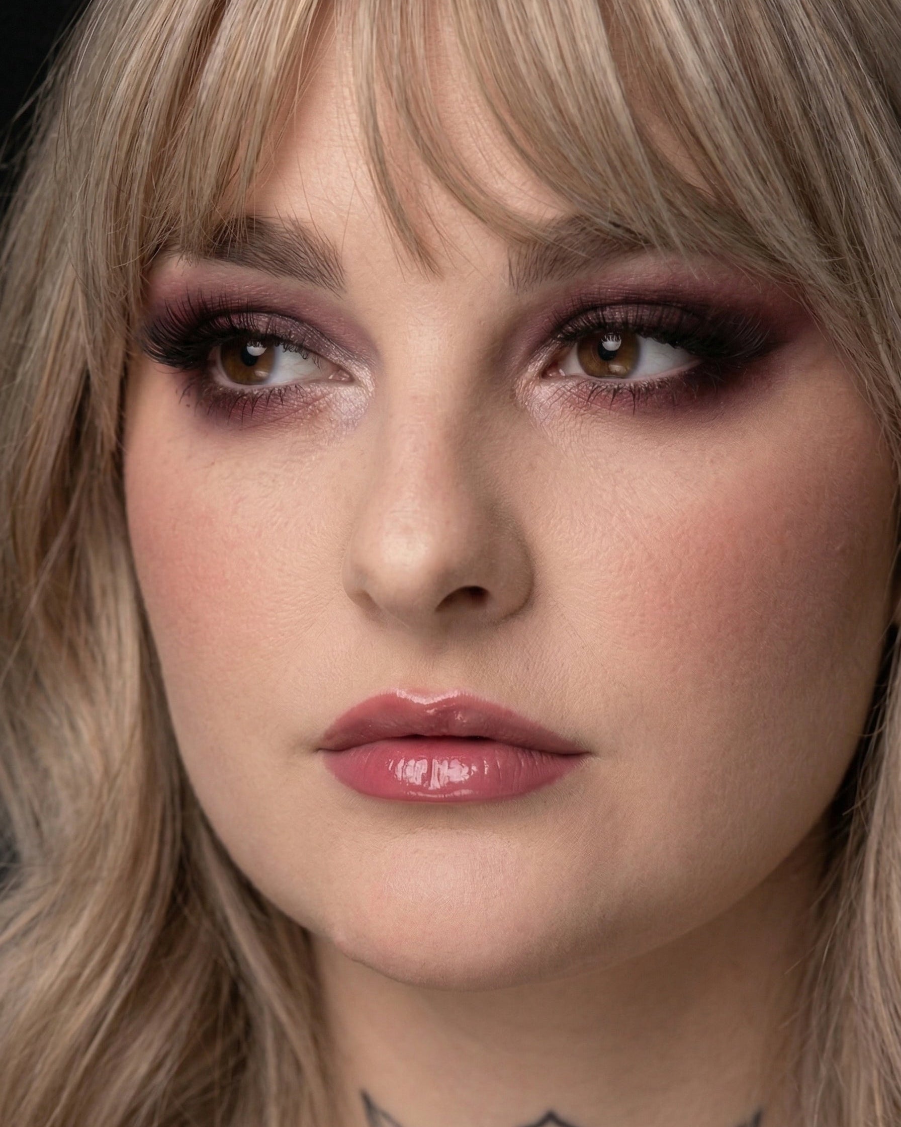 Close-up of a person with blonde hair and dramatic makeup